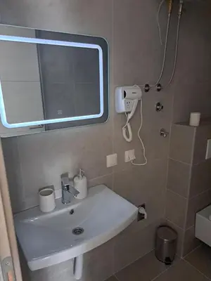 a bathroom with a sink and a mirror at Real Dream in Prijedor