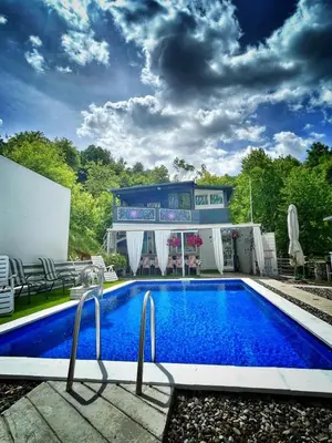 a swimming pool with a building in the background at Vila N&M in Grad