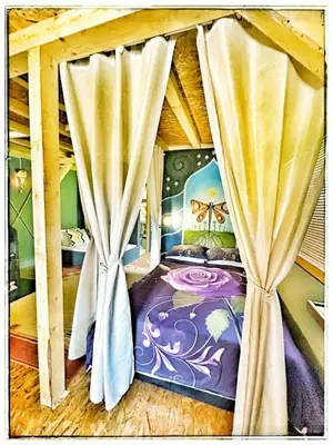 a bedroom with a canopy bed with curtains at Vila N&M in Grad
