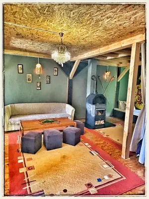 a living room with a table and a fireplace at Vila N&M in Grad