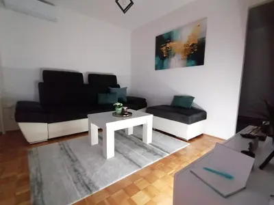 a living room with a couch and a coffee table at Apartman Lamela in Zenica