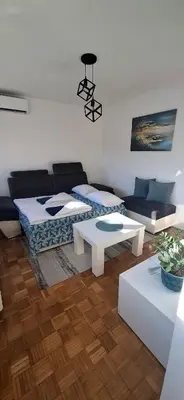 a living room with a couch and a table at Apartman Lamela in Zenica