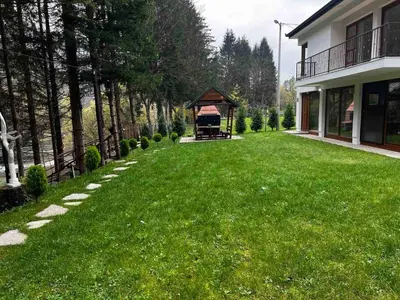 a large yard with a gazebo in a yard at Villa Bella Una-Apartman in Ostrožac