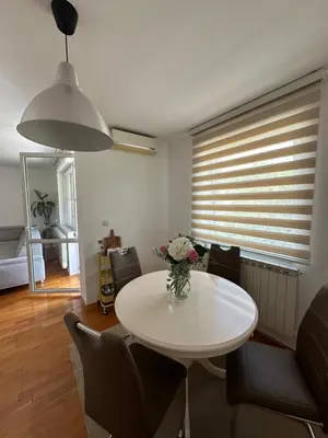 a living room with a white table and chairs at Apartman Siesta in Kiseljak