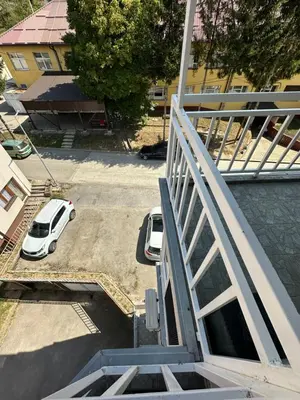 an overhead view of a parking lot with a white car at Apartman Siesta in Kiseljak