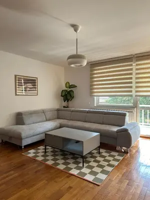 a living room with a couch and a coffee table at Apartman Siesta in Kiseljak