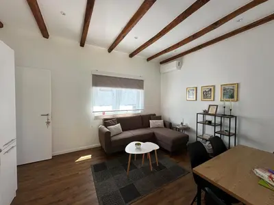 a living room with a couch and a table at Small House Apartment in Bihać