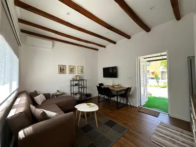 a living room with a couch and a table at Small House Apartment in Bihać