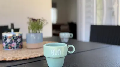 a coffee cup sitting on top of a table at Small House Apartment in Bihać