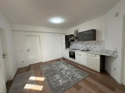 an empty kitchen with white walls and wooden floors at Luxury Pyramid Apartment II Visoko in Visoko