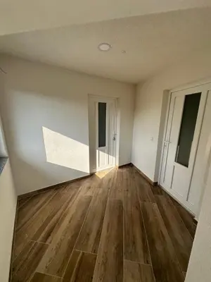 an empty room with wooden floors and white walls at Luxury Pyramid Apartment II Visoko in Visoko
