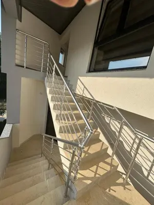 a staircase in a house with a metal railing at Luxury Pyramid Apartment II Visoko in Visoko