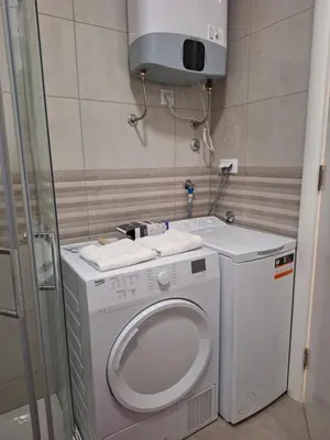 a small bathroom with a washing machine and a shower at DRAGAm in Banja Luka