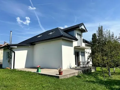 a white house with a black roof at Peace Holiday Home in Bihać