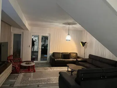 a living room with a couch and a table at Peace Holiday Home in Bihać