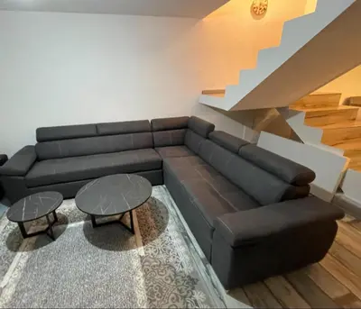 a living room with a couch and a staircase at Peace Holiday Home in Bihać