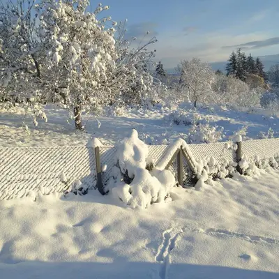 a fence covered in snow in a field at Casa Rado in Banja Luka