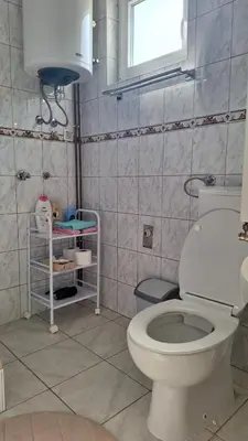 a bathroom with a toilet and a window at Una in Bosanski Novi