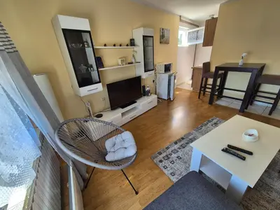 a living room with a chair and a table at Una in Bosanski Novi