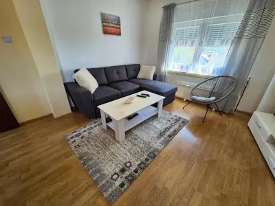 a living room with a blue couch and a coffee table at Una in Bosanski Novi