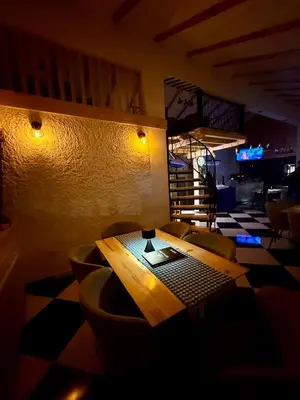 a dining room with a wooden table and chairs at Motel Anić in Novi Travnik