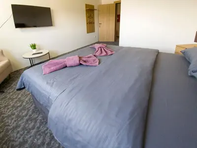 a large bed with two pink towels on it at Motel Anić in Novi Travnik
