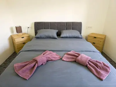 two pink bow ties are on a bed at Motel Anić in Novi Travnik