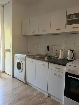 a kitchen with a washing machine and a washer at Apartman KUNA in Drvar