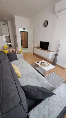 a living room with a couch and a tv at Stan Banjaluka Ada 1 in Rebrovac