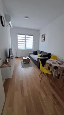 a living room with a couch and a table at Stan Banjaluka Ada 1 in Rebrovac