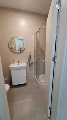 a bathroom with a shower and a sink and a mirror at Stan Banjaluka Ada 1 in Rebrovac