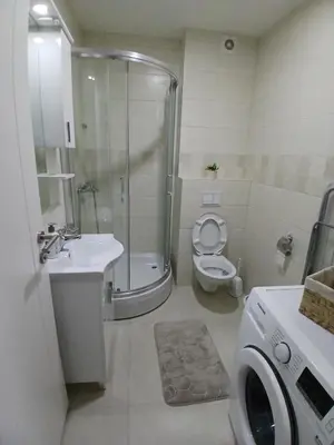 a bathroom with a shower and a toilet and a sink at KEJ LUX Apartman in Bosanska Gradiška