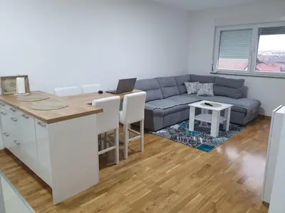 a living room with a couch and a table at KEJ LUX Apartman in Bosanska Gradiška