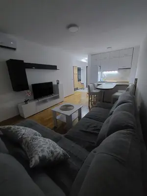 a living room with a couch and a table at KEJ LUX Apartman in Bosanska Gradiška