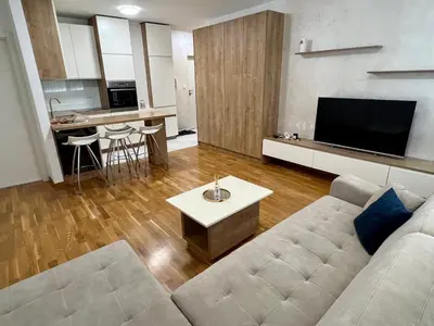 a living room with a couch and a table at Apartman 23 Lux in Banja Luka