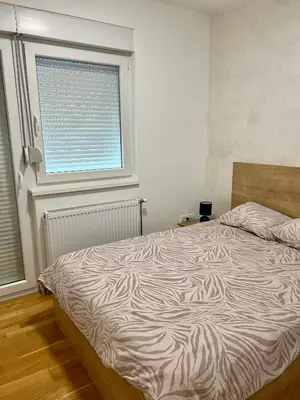 a bedroom with a bed with a zebra print sheets at Apartman 23 Lux in Banja Luka