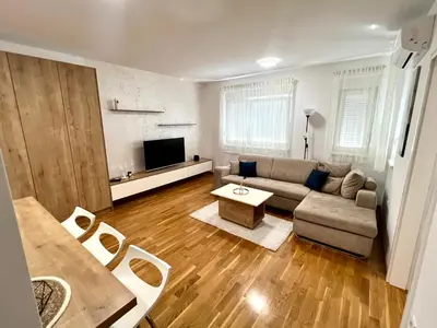a living room with a couch and a table at Apartman 23 Lux in Banja Luka