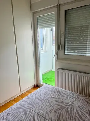 a bedroom with a zebra print bed in front of a window at Apartman 23 Lux in Banja Luka