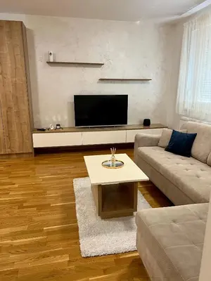 a living room with a couch and a tv at Apartman 23 Lux in Banja Luka