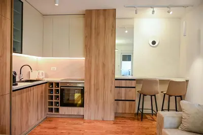 a kitchen and living room with a couch and a counter at Apartmani Galerija in Banja Luka