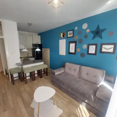 a living room with a couch and a table at Stan na dan centar Jevrejska Banja Luka in Banja Luka