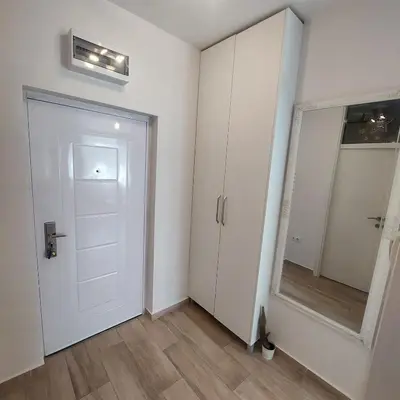 a room with a white door and a mirror at Stan na dan centar Jevrejska Banja Luka in Banja Luka