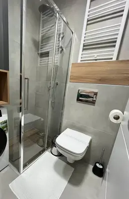 a bathroom with a toilet and a glass shower at Apartman Galerija 1 in Banja Luka