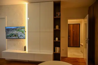a living room with a large white cabinet at Apartman Galerija 1 in Banja Luka