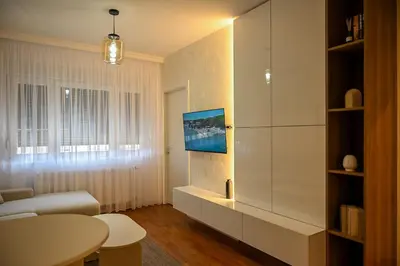 a living room with a couch and a table at Apartman Galerija 1 in Banja Luka