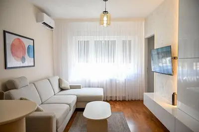 a living room with a couch and a table at Apartman Galerija 1 in Banja Luka