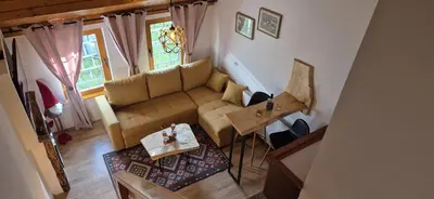 a living room with a couch and a table at Apartmani Viktory in Šišava