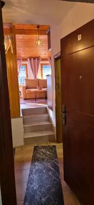 a living room with a couch and a door at Apartmani Viktory in Šišava