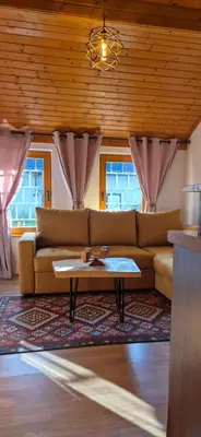 a living room with a couch and a coffee table at Apartmani Viktory in Šišava