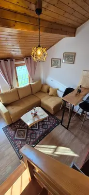 a living room with a couch and a table at Apartmani Viktory in Šišava
